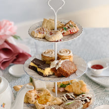 Load image into Gallery viewer, Three-tiered cake stand with assorted pastries on a table with tea set
